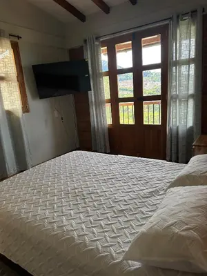 a large bed in a bedroom with a window at Finca El Encanto in Jericó