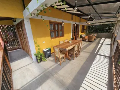an outdoor patio with a wooden table and chairs at Finca El Encanto in Jericó