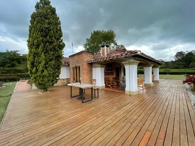 a wooden deck with a pavilion on a house at Espectacular villa en llanogrande in Estación El Salto