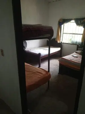 a room with three bunk beds and a window at Rincón del río in San Carlos