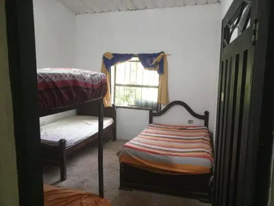 a bedroom with two bunk beds and a window at Rincón del río in San Carlos
