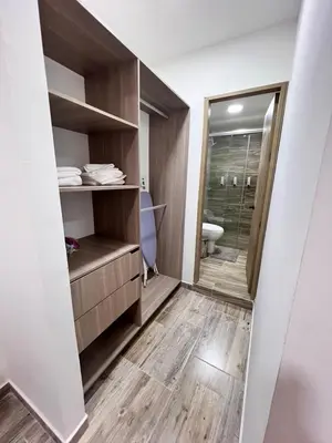 a bathroom with a toilet and a walk in shower at Meraki Urban Lofts in Quibdó