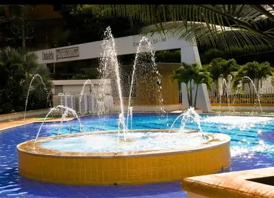 a fountain in the middle of a swimming pool at Cabaña San Jerónimo in San Jerónimo