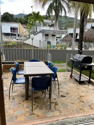 a patio with a table and chairs and a grill at Cabaña San Jerónimo in San Jerónimo