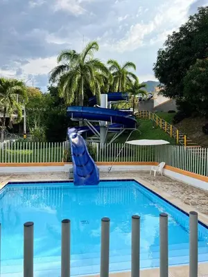 a blue dolphin statue sitting next to a swimming pool at Cabaña ciudadela premium San Jerónimo in San Jerónimo