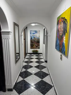 a hallway with a checkered floor and paintings on the walls at Hermoso,amplio y central apartamento en Medellin in Medellín
