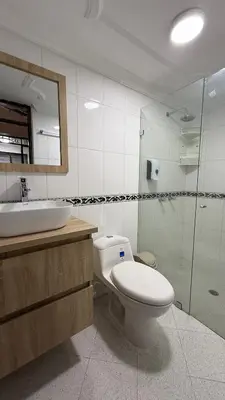 a bathroom with a toilet and a sink and a shower at Hermoso,amplio y central apartamento en Medellin in Medellín