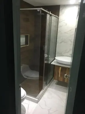 a bathroom with a shower and a toilet and a sink at Glen de 3 alcobas los molinos in Medellín
