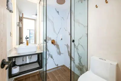 a bathroom with a shower and a toilet and a sink at M301 Poblado Apt close to lleras park jacuzzi AC in Medellín
