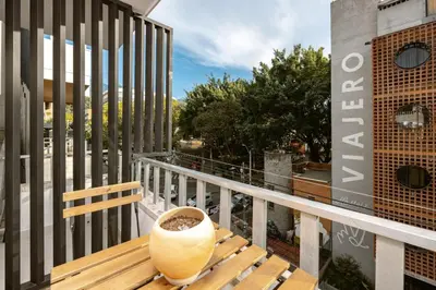 a wooden bench sitting on top of a balcony at M301 Poblado Apt close to lleras park jacuzzi AC in Medellín