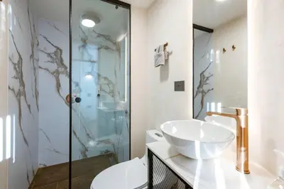 a bathroom with a sink and a shower at M301 Poblado Apt close to lleras park jacuzzi AC in Medellín