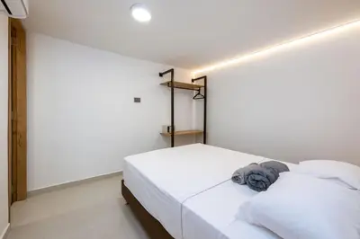 a bedroom with a bed with white sheets at M301 Poblado Apt close to lleras park jacuzzi AC in Medellín