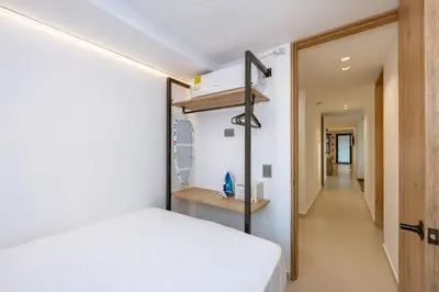 a bedroom with a bed and a hallway at M301 Poblado Apt close to lleras park jacuzzi AC in Medellín