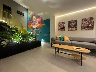 a living room with a couch and a table at 7BR Poblado House close to Lleras Park Jacuzzi AC in Medellín