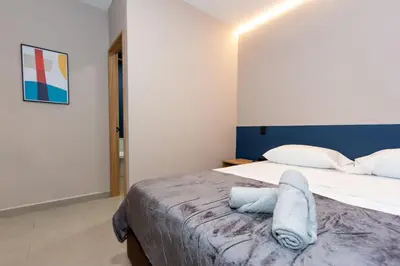 a bedroom with a bed with a towel on it at 7BR Poblado House close to Lleras Park Jacuzzi AC in Medellín