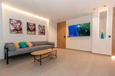a living room with a couch and a table at 7BR Poblado House close to Lleras Park Jacuzzi AC in Medellín