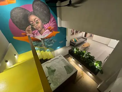 an overhead view of a room with a painting of a woman at 7BR Poblado House close to Lleras Park Jacuzzi AC in Medellín