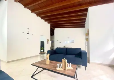 a living room with a blue couch and a table at R301 Apartment close to Lleras park and Provenza in Medellín