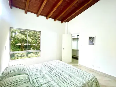 a bedroom with a large bed and a window at R301 Apartment close to Lleras park and Provenza in Medellín