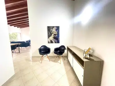 a room with two black chairs and a table at R301 Apartment close to Lleras park and Provenza in Medellín
