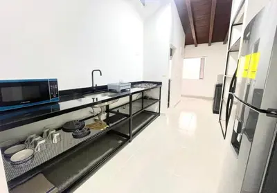 a kitchen with a counter top with a microwave at R301 Apartment close to Lleras park and Provenza in Medellín