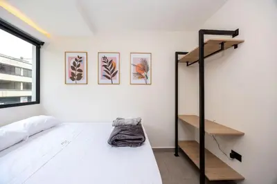 a bedroom with a bunk bed and a ladder at L301 4BR Lleras Park Apt Rooftop Jacuzzi AC in Medellín