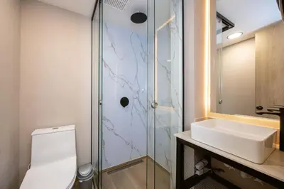 a bathroom with a toilet and a sink and a shower at L301 4BR Lleras Park Apt Rooftop Jacuzzi AC in Medellín