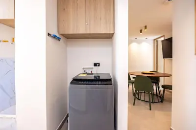 a small kitchen and dining room with a table at L301 4BR Lleras Park Apt Rooftop Jacuzzi AC in Medellín