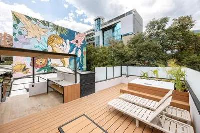 a balcony with a mural on the side of a building at L301 4BR Lleras Park Apt Rooftop Jacuzzi AC in Medellín