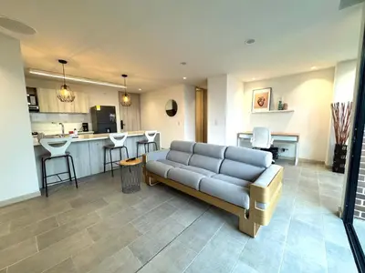 a living room with a couch and a kitchen at SF501 Poblado Manila KBed Parking 247 security in Medellín