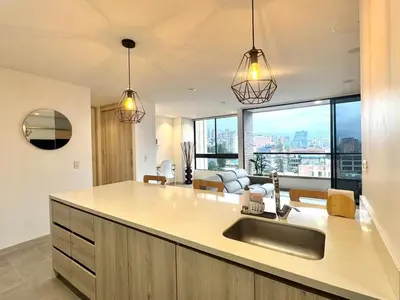 a kitchen with a sink and a living room at SF501 Poblado Manila KBed Parking 247 security in Medellín