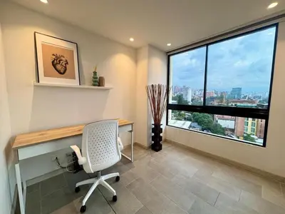 a office with a desk and a chair and a window at SF501 Poblado Manila KBed Parking 247 security in Medellín