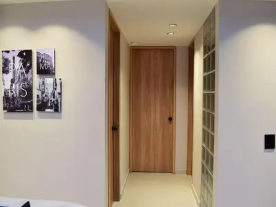 a hallway with a wooden door in a house at 5BR Poblado House to close LlerasPark Jacuzzi AC in Medellín