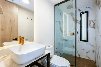 a bathroom with a sink and a toilet and a shower at M501 Poblado Apt close to lleras park jacuzzi AC in Medellín
