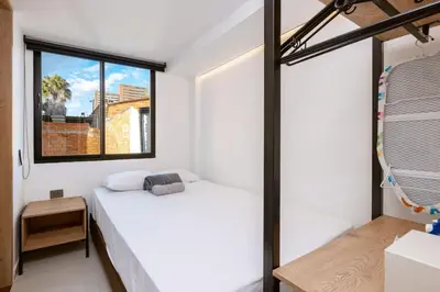 a bedroom with a white bed and a window at M501 Poblado Apt close to lleras park jacuzzi AC in Medellín