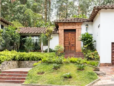a house with a wooden door in a yard at CH51 Colonial Charm Villa at El Poblado Jacuzzi in Medellín