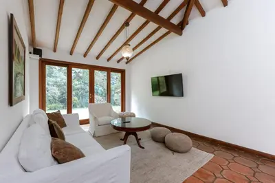 a living room with a white couch and a table at CH51 Colonial Charm Villa at El Poblado Jacuzzi in Medellín