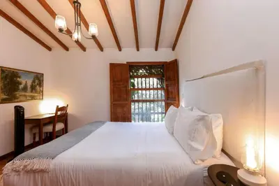 a bedroom with a large white bed with a window at CH51 Colonial Charm Villa at El Poblado Jacuzzi in Medellín