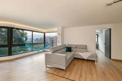 a living room with a couch and large windows at B1 Apt de 3 Alcobas en Poblado Provenza con Aire in Medellín
