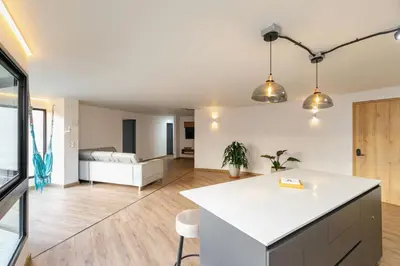 a kitchen and living room with a white counter top at B1 Apt de 3 Alcobas en Poblado Provenza con Aire in Medellín