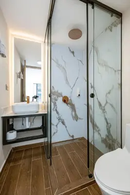 a bathroom with a shower and a toilet and a sink at M54 Poblado 10BR 2 Apts with 2 Jacuzzis and AC in Medellín