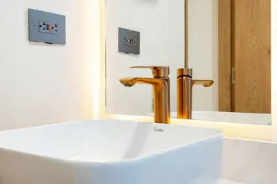 a bathroom with a white sink and a faucet at M54 Poblado 10BR 2 Apts with 2 Jacuzzis and AC in Medellín
