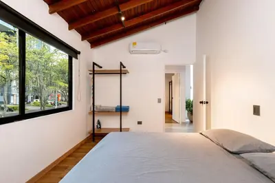 a bedroom with a bed and a large window at L2 2BR Laureles Apartment Jacuzzi AC in Medellín