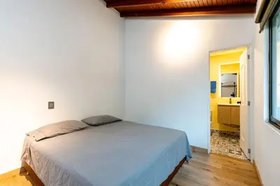 a bedroom with a bed in a white room at L2 2BR Laureles Apartment Jacuzzi AC in Medellín