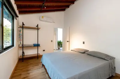 a bedroom with a bed and a large window at L2 2BR Laureles Apartment Jacuzzi AC in Medellín