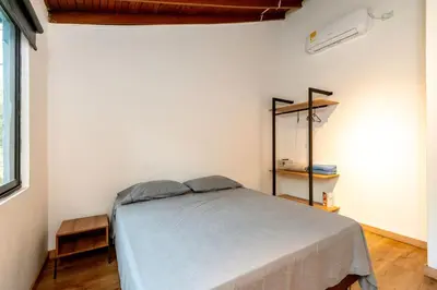 a bedroom with a bed in a white room at L2 2BR Laureles Apartment Jacuzzi AC in Medellín