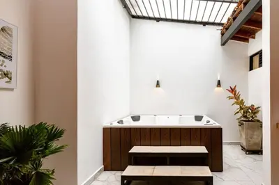 a bathroom with a bath tub with two benches at L2 2BR Laureles Apartment Jacuzzi AC in Medellín