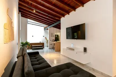 a living room with a couch and a tv at L2 2BR Laureles Apartment Jacuzzi AC in Medellín