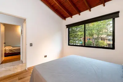 a bedroom with a bed and a large window at L2 2BR Laureles Apartment Jacuzzi AC in Medellín