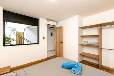 a room with a large mirror and a bed at L1 7BR Laureles House rooftop jacuzzi AC in Medellín